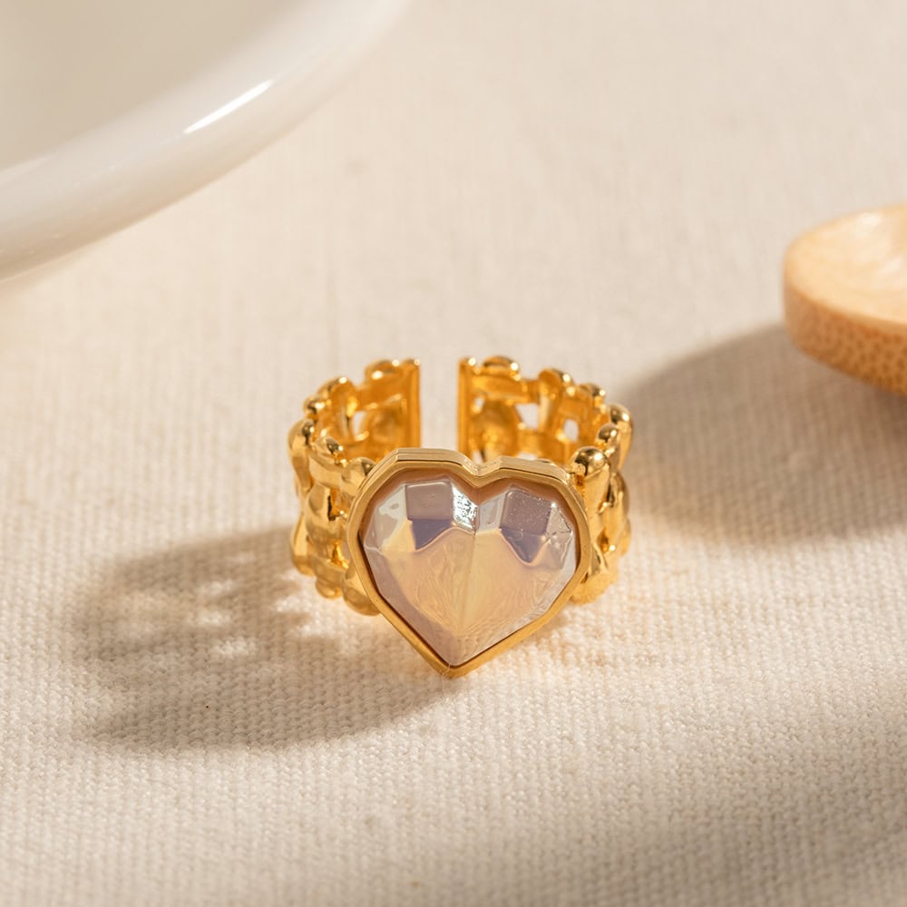 Elegant gold ring featuring a heart-shaped, iridescent gemstone, perfect for stylish accessories and special occasions.