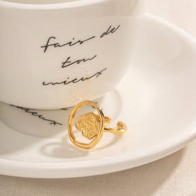 Gold ring featuring a distinctive textured face design, perfect for stylish accessories or gift ideas, available at Monalisa Store.