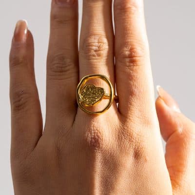 Stunning gold ring featuring detailed craftsmanship, showcased on a person's finger, exemplifying luxury jewelry from Monalisa Store. Perfect for those seeking unique, high-end accessories.