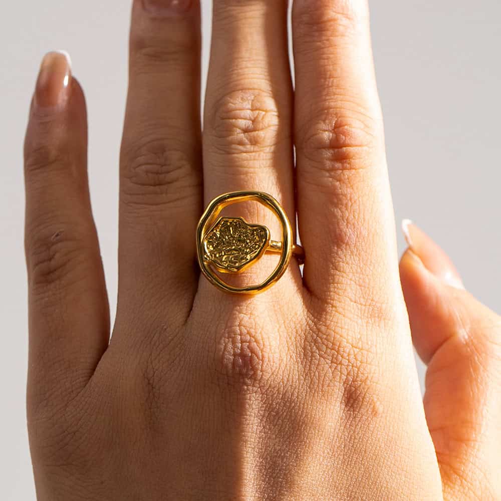 Stunning gold ring featuring detailed craftsmanship, showcased on a person's finger, exemplifying luxury jewelry from Monalisa Store. Perfect for those seeking unique, high-end accessories.