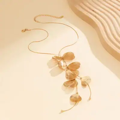 Beautiful gold necklace with leaf-shaped pendants, perfect for women's jewelry collection and accessory enhancement.