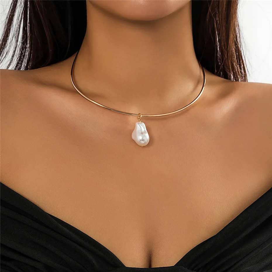 Luxurious pearl pendant on a sleek gold choker, perfect for upscale jewelry shopping and enhancing your elegant look.