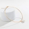 Gold choker necklace with a dangling pearl for stylish elegance and sophistication. Perfect accessory for formal or casual fashion statements.