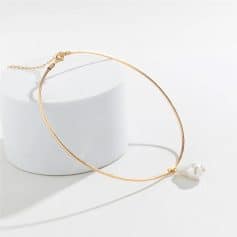 Gold choker necklace with a dangling pearl for stylish elegance and sophistication. Perfect accessory for formal or casual fashion statements.