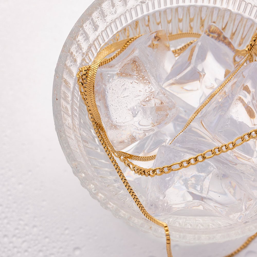 High-quality gold necklaces displayed on ice cubes in a glass bowl, showcasing luxury jewelry for women available at Monalisa Store. Perfect for gifting or personal wear.