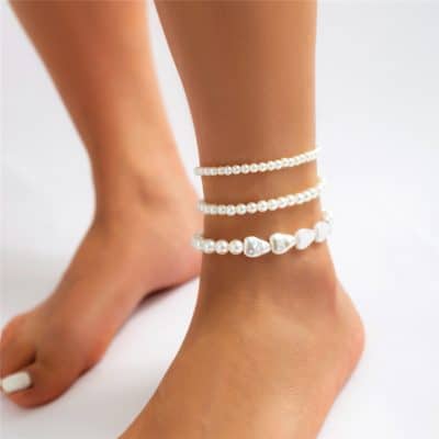 Close-up of stylish pearl anklets worn on a woman's ankle, showcasing trendy jewelry accessories perfect for enhancing any outfit and emphasizing elegant fashion.