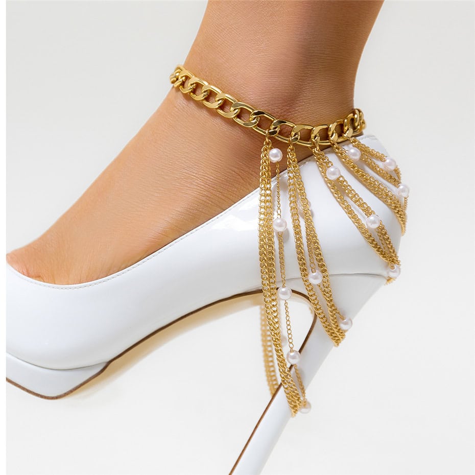 Stylish gold chain ankle bracelet adorned with pearls, perfect for luxury footwear and accessory collection. Enhance your elegant look with this trendy piece.