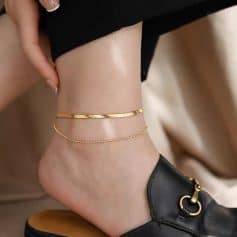 A close-up of gold jewelry on a woman's ankle highlighting trendy anklets and bracelets at Monalisa Store.