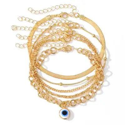 Elegant gold chain jewelry collection including layered necklaces and bracelets with an eye charm, perfect for enhancing your style and adding a luxurious touch.
