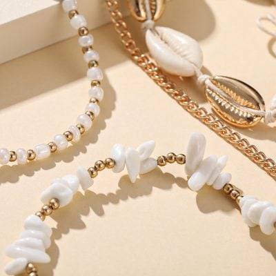Beautiful shell and pearl jewelry necklaces showcasing coastal-inspired fashion accessories for women.
