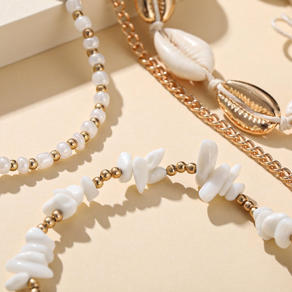 Beautiful shell and pearl jewelry necklaces showcasing coastal-inspired fashion accessories for women.