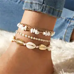 Delicate white shell and gold bracelets, perfect for beach-inspired jewelry and casual summer accessory styling.