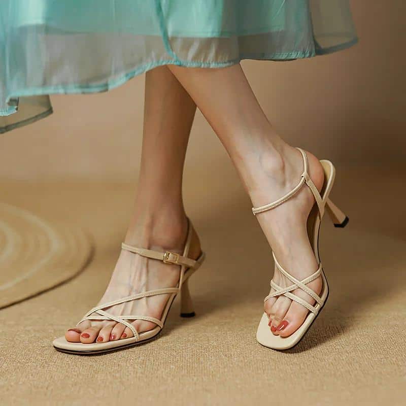 Comfortable nude high heel sandals for women, perfect for summer parties and stylish occasions. Features thin straps, ankle buckle, and a chic design for a sophisticated look.