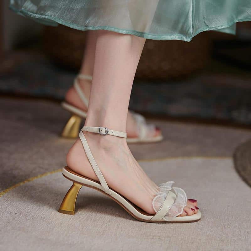 Stylish women's high-heeled sandals with ankle straps, delicate ruffles, and gold accents, perfect for fashion-forward occasions. Comfortable yet chic footwear from Monalisa Medical Store.