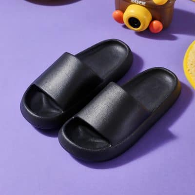 Comfortable black slides for casual indoor wear and eye care routines.