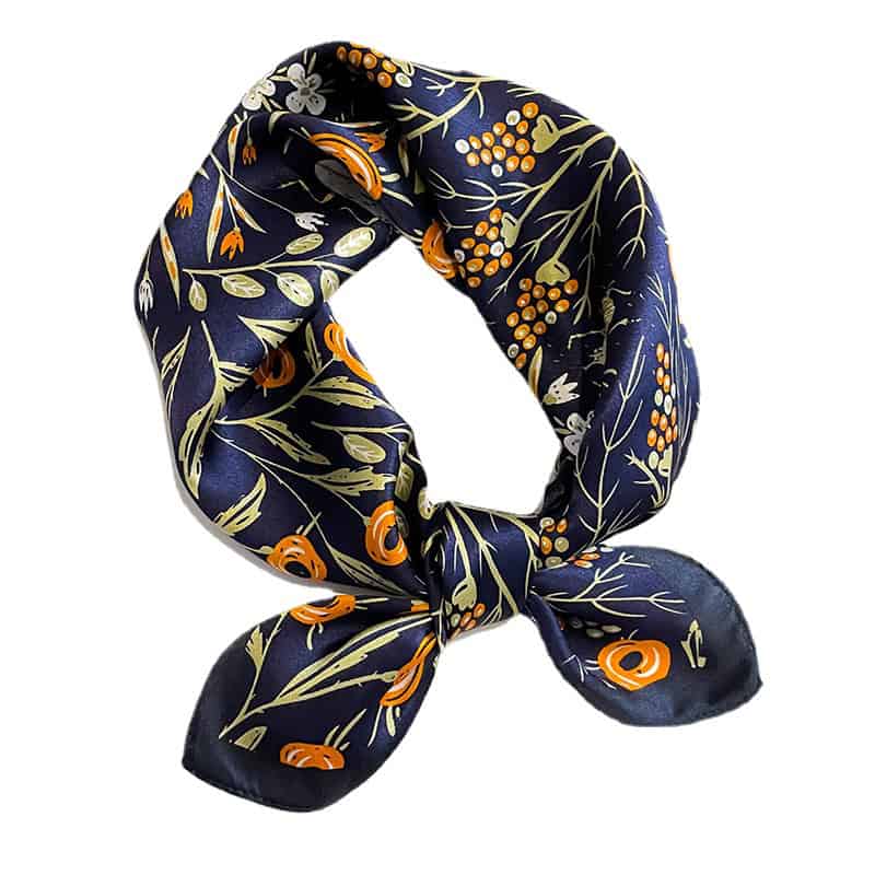 Stylish navy blue silk scarf featuring floral and leaf patterns in orange, white, and beige, perfect for adding elegance to your wardrobe.