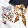 Vibrant floral hair scarves crafted from lightweight fabric, perfect for adding a stylish touch to your hairstyle. Ideal for daily wear or special occasions, these scarves combine comfort and fashion.