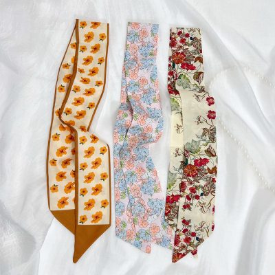 Colorful floral scarves with different patterns, ideal for adding a touch of elegance and freshness to your wardrobe.