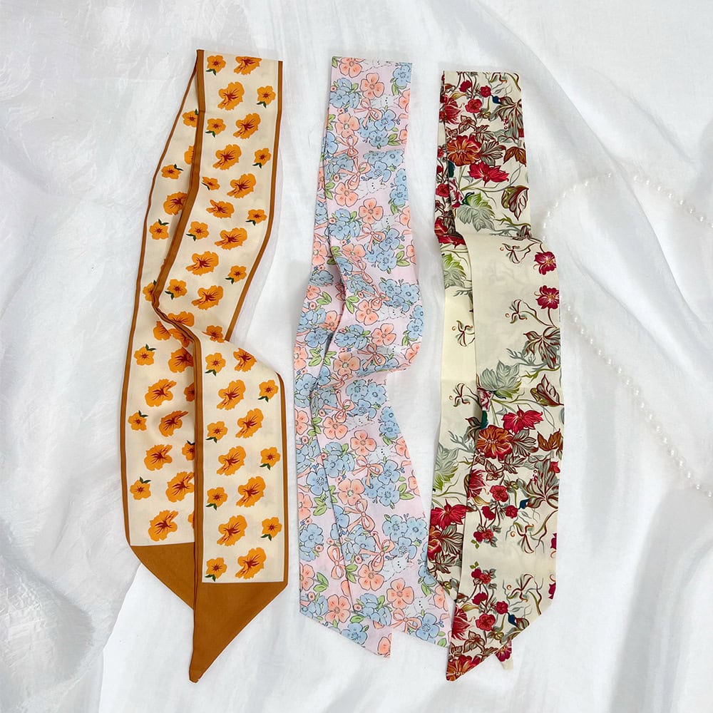 Colorful floral scarves with different patterns, ideal for adding a touch of elegance and freshness to your wardrobe.