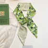 Luxurious green floral silk scarf perfect for stylish accessories and face mask replacement, enhancing your fashion statement with quality and comfort.