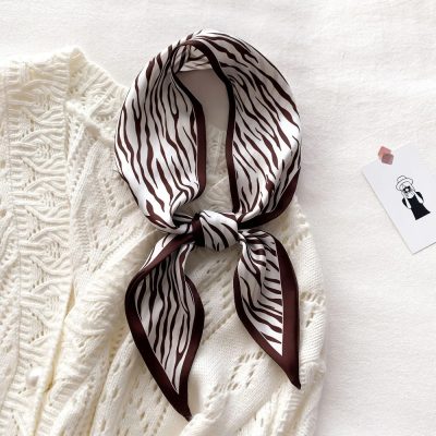 Luxurious zebra pattern silk scarf ideal for women’s fashion accessories, versatile styling, and elegant look. Perfect for enhancing outfits with trendy and sophisticated accessories.