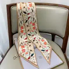 Fine silk floral scarf with vibrant red, orange, and green patterns, perfect for fashion accessories and gift ideas. Enhance your style with this luxurious, high-quality silk scarf.