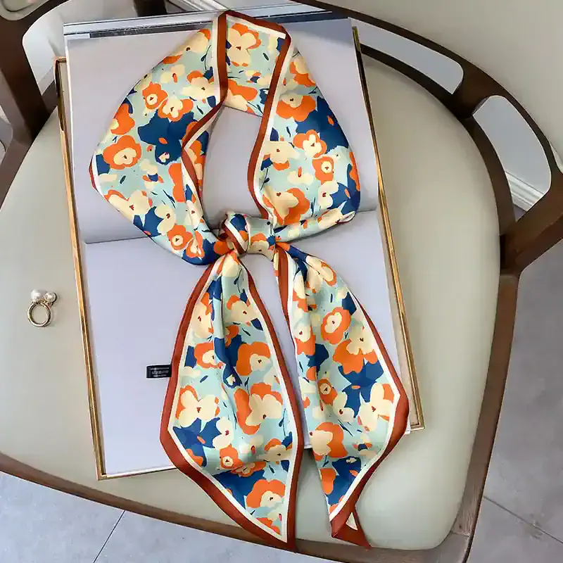 Silk floral scarf with vibrant colors, perfect for fashion accessories and making a statement.