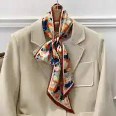 Versatile floral-patterned silk scarf styled around a beige blazer, ideal for enhancing your fashion statement with sophistication and colorful appeal.