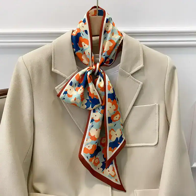 Versatile floral-patterned silk scarf styled around a beige blazer, ideal for enhancing your fashion statement with sophistication and colorful appeal.