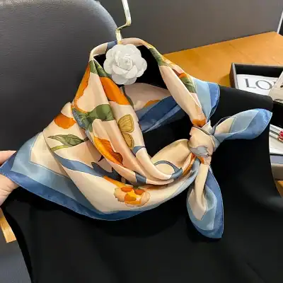 Silk scarf with vibrant floral pattern, perfect for stylish women looking for luxury accessories and fashion statement pieces.