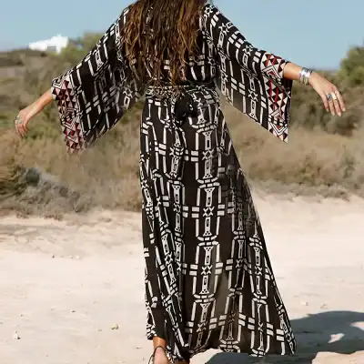 Stylish black and white boho maxi dress with flowy sleeves, perfect for beachwear and resort lounging, featuring geometric patterns for a contemporary look.