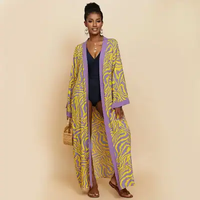 Vibrant purple and yellow zebra print long kimono with bohemian design, ideal for beachwear, and casual summer outfits, adding style and comfort.