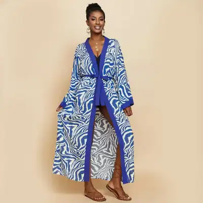 Stylish zebra print kimono with vibrant blue accents, perfect for trendy fashion. Made from lightweight, breathable fabric for comfortable wear. Ideal for women seeking chic, versatile clothing options.