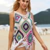 A woman modeling a vibrant, colorful crochet beach coverup on the beach, perfect for summer fashion and sun protection, showcasing trendy coverups from Monalisa Store.
