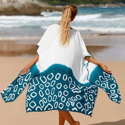 Stylish beach cover-up with bold blue and white patterns, perfect for summer seaside trips and sun protection.