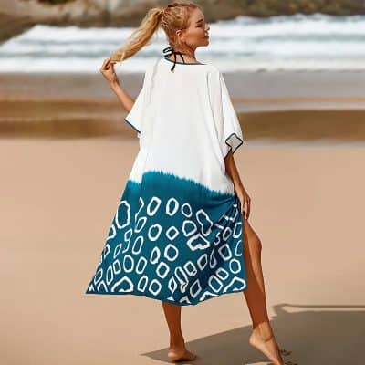 Elegant beach cover-up with stylish blue and white pattern, perfect for seaside vacations and resort wear. Soft, lightweight fabric ideal for comfortable summer days at the beach or poolside.