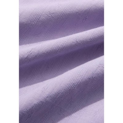 Close-up image of elegant purple fabric showcasing a smooth texture and subtle sheen, ideal for upscale apparel and tailored medical uniforms.