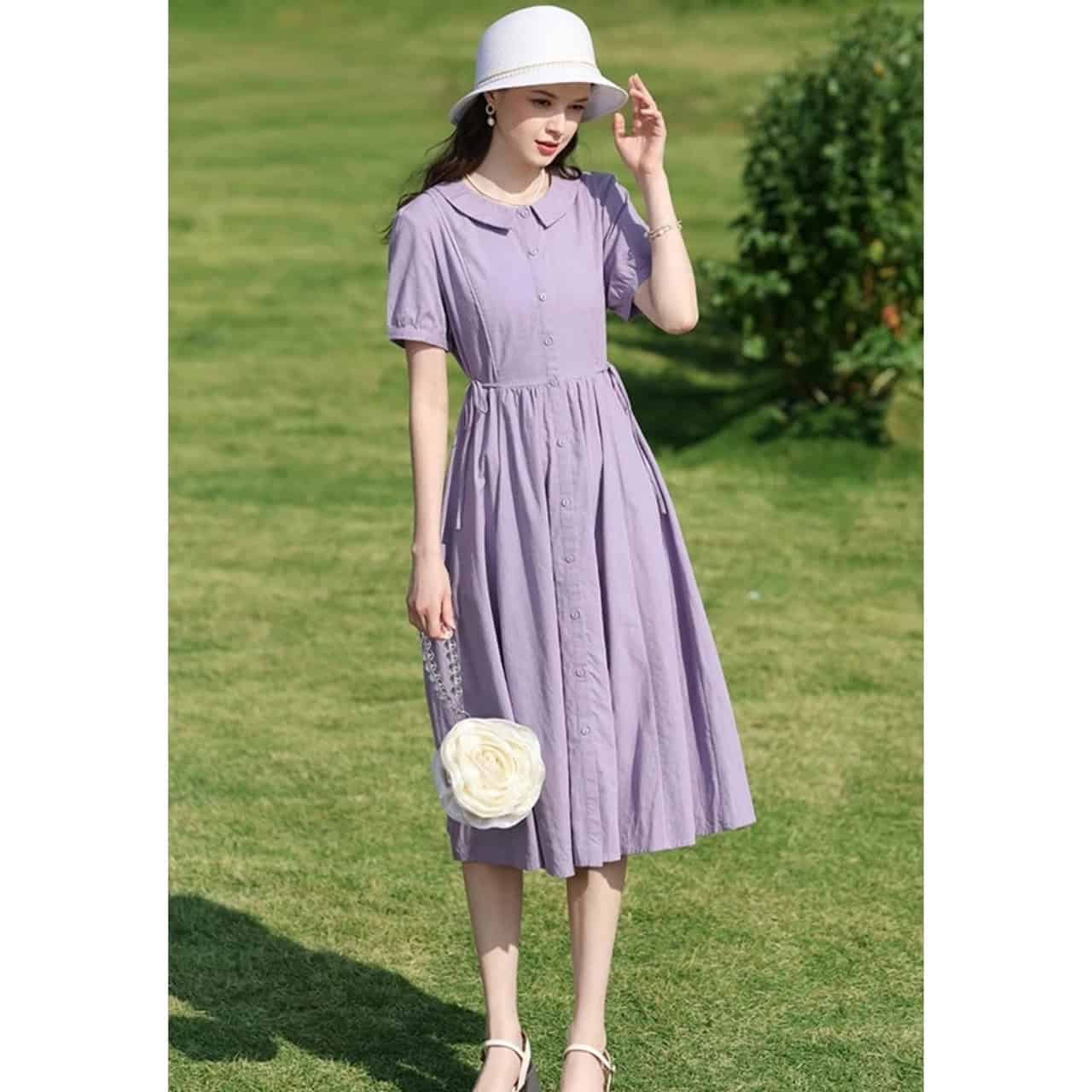 Stylish lavender midi dress with button-down front, short puff sleeves, and a cinched waist, perfect for summer outings and casual occasions.