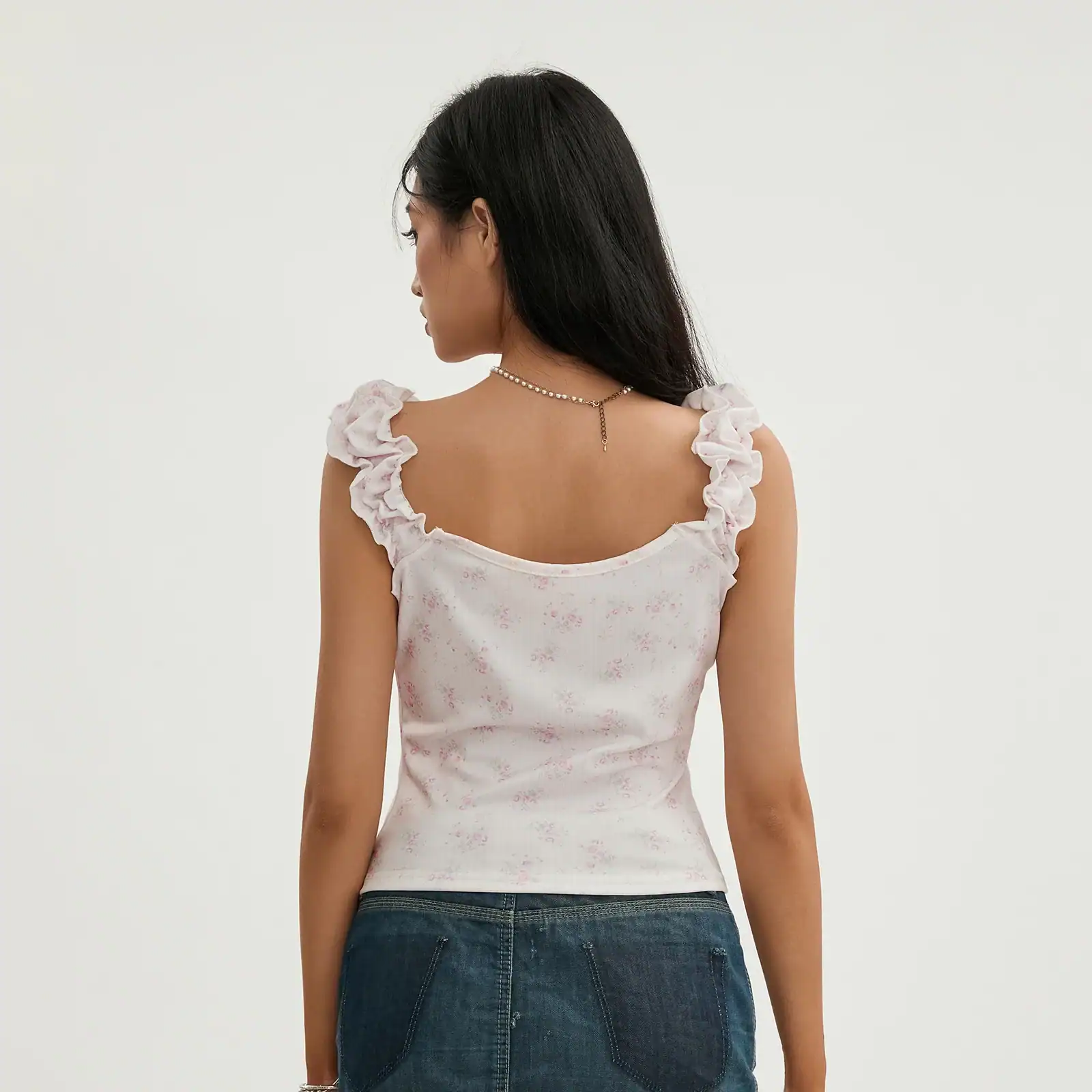 Elegant floral sleeveless top with ruffle shoulder details, perfect for casual outings and enhancing your fashion statement.