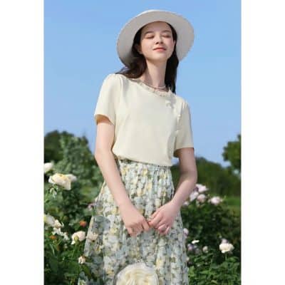 Beautiful woman outdoors in floral skirt and summer hat, enjoying sunshine in a scenic garden, perfect for fashion, style, and outdoor accessories from Monalisa Medical.