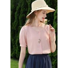 Elegant pink women's blouse with embroidery, short puff sleeves, and button front, made from lightweight, breathable fabric for a chic and comfortable look.