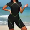 Enhanced women's wetsuit for swimming, surfing, and water sports featuring a sleek black design with vibrant green trim, designed for comfort, durability, and style during beach activities, pool laps, and open water swims.