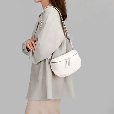 Stylish white crossbody bag with multiple zip compartments, perfect for daily use and fashion-forward outfits. Enhances your look while offering practical storage solutions.