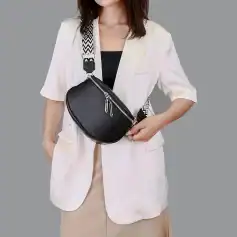 Elegant black leather crossbody bag with silver zipper detail, perfect for fashion-forward accessories.