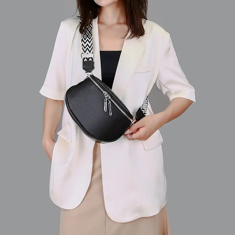 Elegant black leather crossbody bag with silver zipper detail, perfect for fashion-forward accessories.