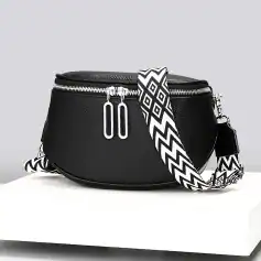 Stylish black leather crossbody bag with silver zippers and a bold black and white patterned strap, perfect for fashion-forward accessories and daily convenience.