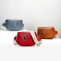 High-quality leather handbags in red, gray, and brown with stylish patterned straps, perfect for fashion-forward individuals. Durable, elegant, and versatile accessories for daily use or special occasions.