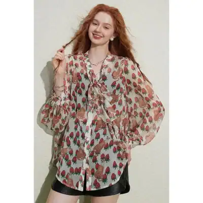 A fashionable, printed women's blouse featuring a playful design with ruffled ties, perfect for casual or office wear, available at Monalisa Store.