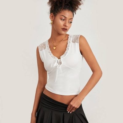 Stylish white sleeveless top with lace detail and front tie, perfect for casual or office wear, available at Monalisa Store, enhancing your wardrobe with trendy fashion pieces.