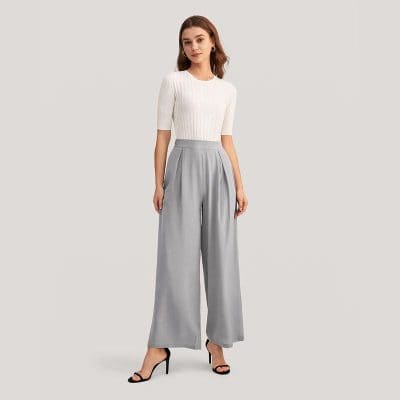 Elegant woman fashion look, casual yet sophisticated style with a white top and wide-leg gray trousers, suitable for office, meetings, or social events.